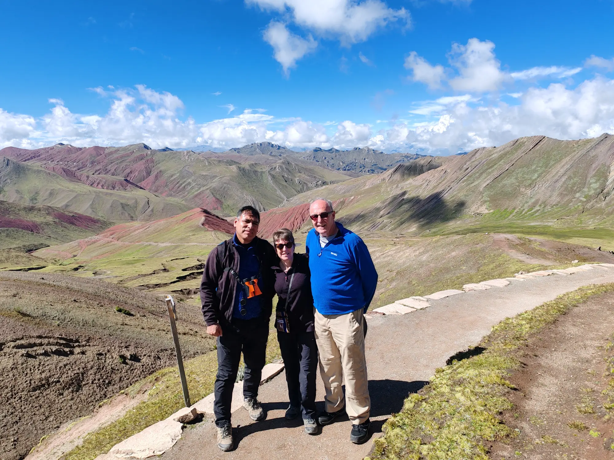 Travellers together at the foot of Vinicunca
